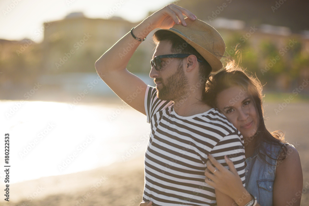 Happy woman embracing her boyfriend at seaside
