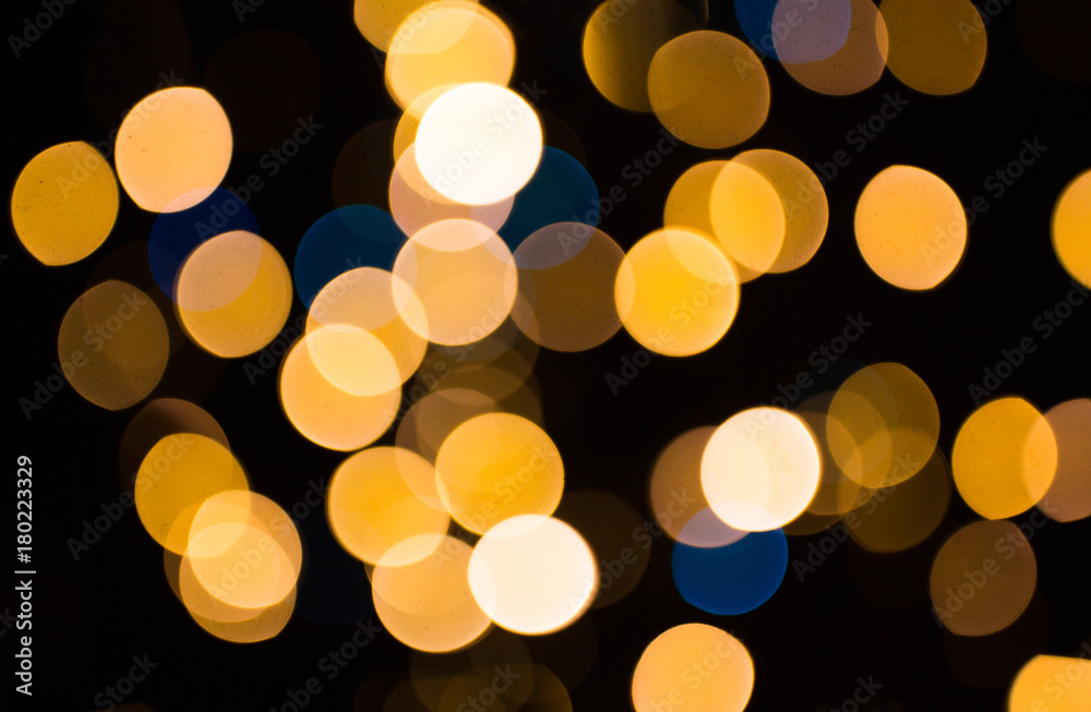 blurred golden lights over dark background blurred golden lights over dark background