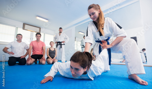 Female coach showing painful hold