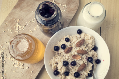 Delicious oatmeal porridge with berry and almonds for breakfast.