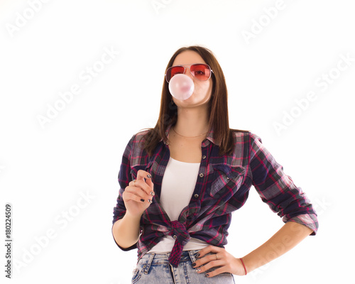 Young cute girl chews bubble gum, isolated  