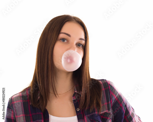 Young cute girl chews bubble gum, isolated  