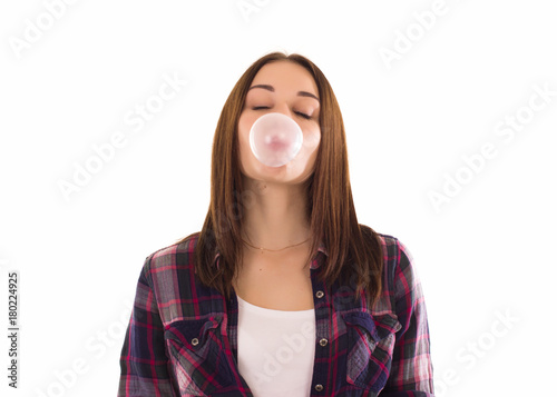 Young cute girl chews bubble gum, isolated  