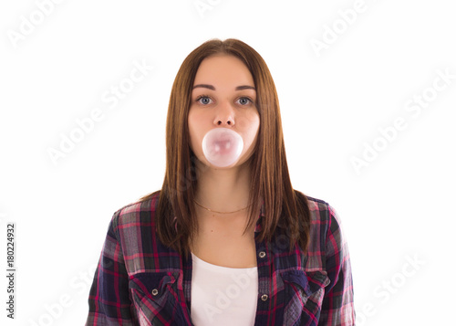 Young cute girl chews bubble gum, isolated  