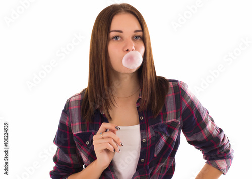Young cute girl chews bubble gum, isolated  