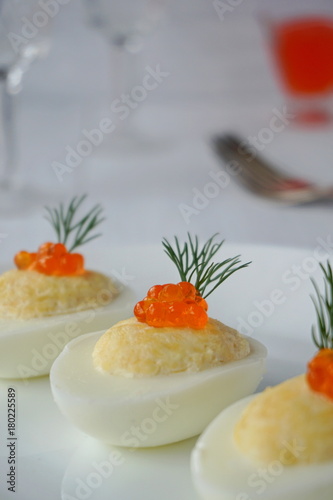 Stuffed eggs with caviar, cheese and mayonnaise