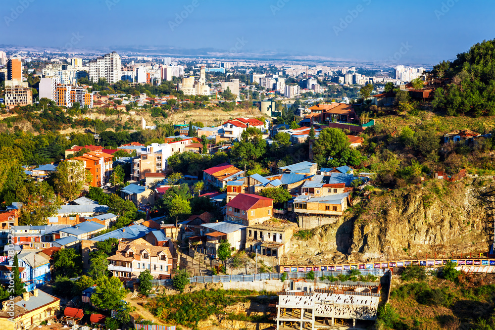 Fototapeta premium Tourustic ride on the funicular, aerial view from the top on the houses with traditional wooden carving balconies of Old Town of Tbilisi, Georgia