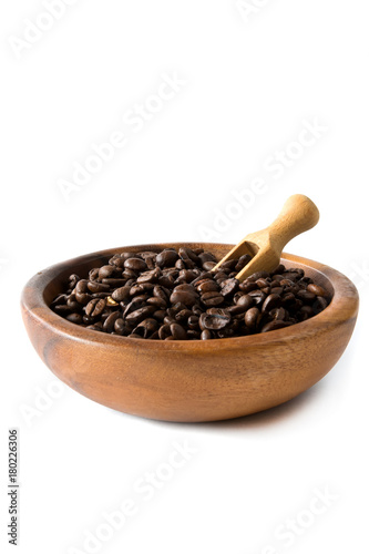 Coffee beans close-up in a wooden bowl of isolate on a white background