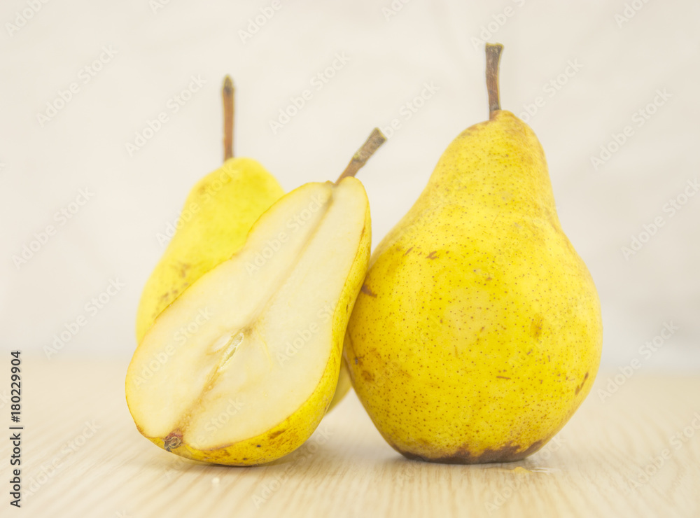 Fresh, juicy pear on a wooden base and white background color Fresh, juicy pear on a wooden base and white background color