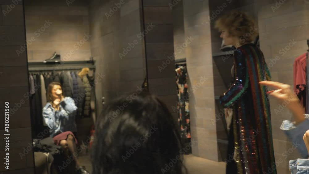 Young girls fool around in the locker room of an expensive store. Young girls fool around in the locker room of an expensive store.
