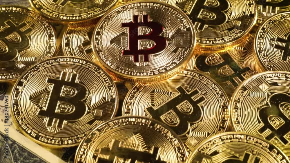 Gold Bit Coin BTC coins and dollar bills.