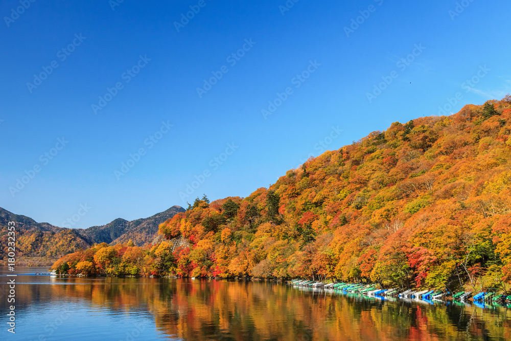 View of Chuzenji lake in autumn season with reflection water in Nikko, Japan View of Chuzenji lake in autumn season with reflection water in Nikko, Japan
