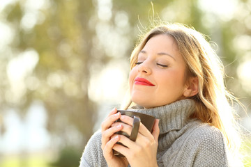 Relaxed girl breathing outdoors in winter