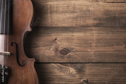 Vintage violin musical equipment on wooden desk background