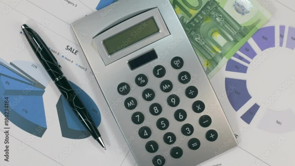 Rotation of the diagrams with a calculator and banknote hundred euros. Rotation of the diagrams with a calculator and banknote hundred euros.