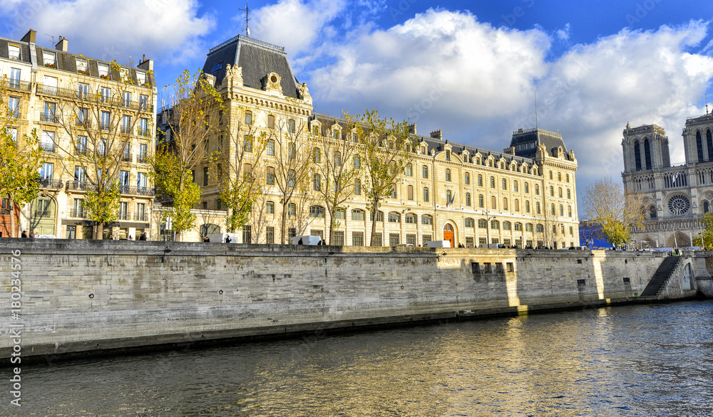 Notre Dame Cathedral and city buildings along Seine river, Paris - France
