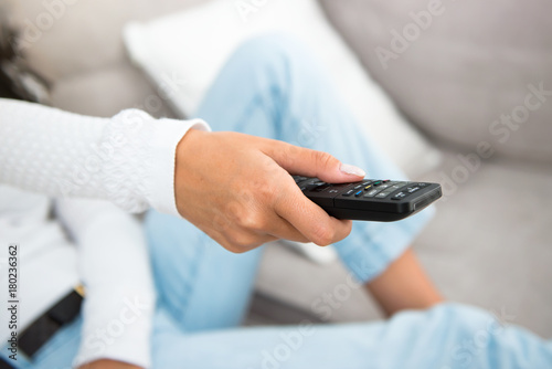 Girl with a television remote