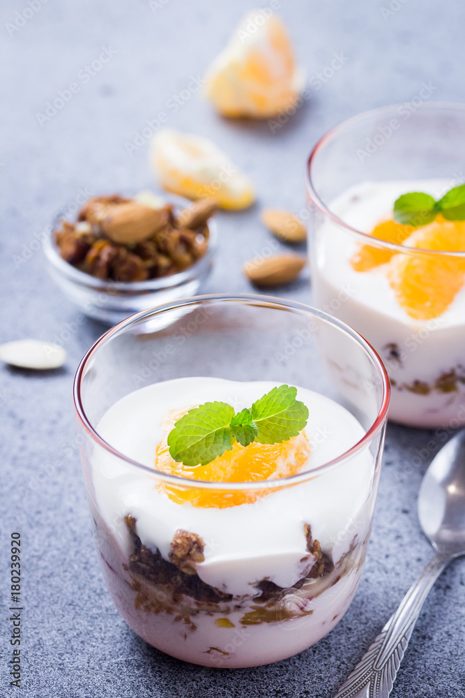 Yogurt granola citrus dessert on concrete background. Selective focus, cpace for text. Yogurt granola citrus dessert on concrete background. Selective focus, cpace for text.