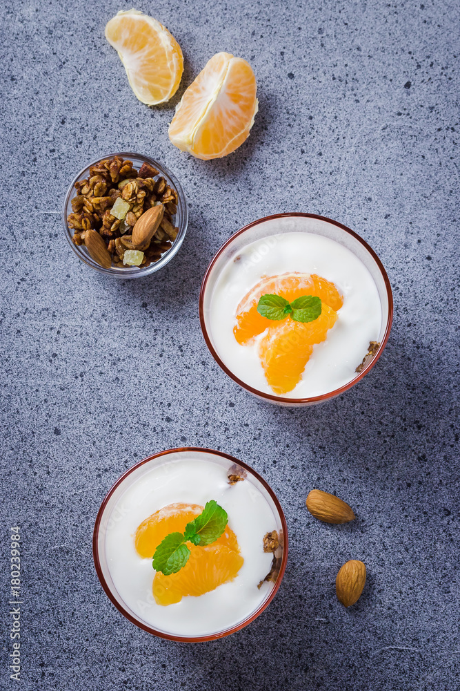 Overnight yogurt fruit muesli breakfast on concrete background. Top view, copy space. Overnight yogurt fruit muesli breakfast on concrete background. Top view, copy space.