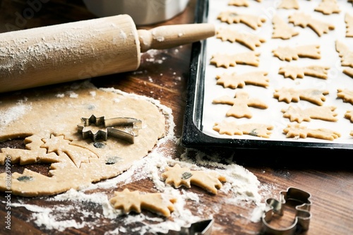 Baking Christmas Cookies / Cookie cutter, rolling pin, dough and baking sheet on wooden table
