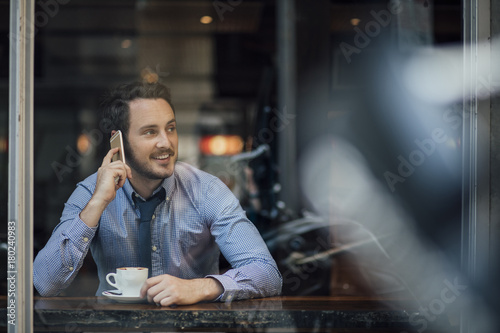 Businessman Talking On Phone In Cafe