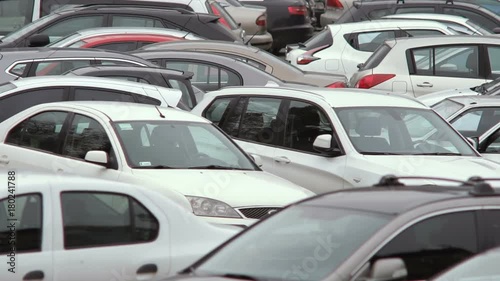A large number of cars from different manufacturers are parked in the city. Close-up
