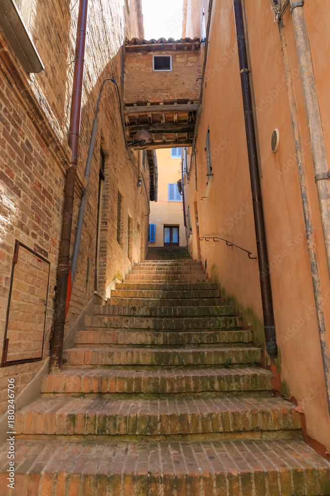 Urbino, Italy - August 9, 2017: a narrow tunnel. the passage between residential buildings.
