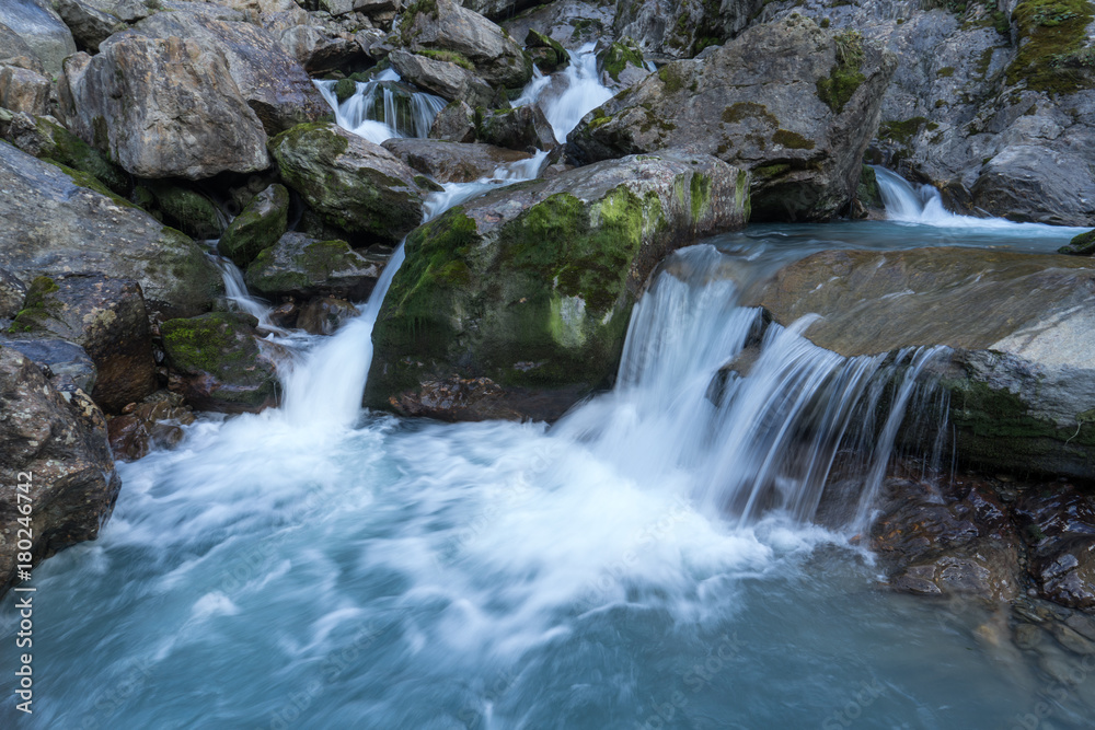 Mountain river and stones landscape natural environment. Hiking in the alps. Grawa Waterfall in Stubai Valley, Tyrol, Austria Mountain river and stones landscape natural environment. Hiking in the alps. Grawa Waterfall in Stubai Valley, Tyrol, Austria