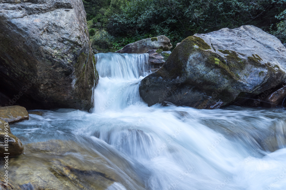 Mountain river and stones landscape natural environment. Hiking in the alps. Grawa Waterfall in Stubai Valley, Tyrol, Austria Mountain river and stones landscape natural environment. Hiking in the alps. Grawa Waterfall in Stubai Valley, Tyrol, Austria