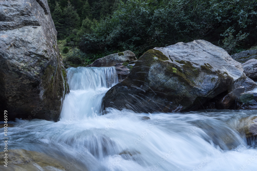 Mountain river and stones landscape natural environment. Hiking in the alps. Grawa Waterfall in Stubai Valley, Tyrol, Austria Mountain river and stones landscape natural environment. Hiking in the alps. Grawa Waterfall in Stubai Valley, Tyrol, Austria