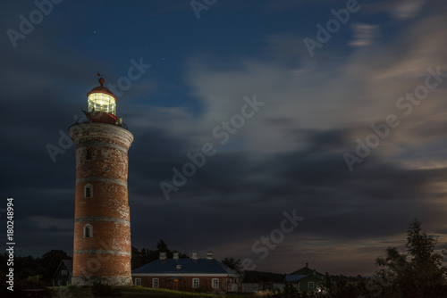Lighthouse and house in the Baltic Sea. Shore, evening light, sunset, clouds and architecture concept. Mohni, small island in Estonia, Europe.