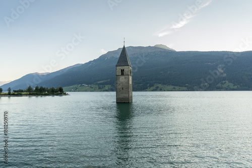 Church under water  drowned village  mountains landscape and peaks in background. Reschensee Lake Reschen Lago di Resia. Italy  Europe  S  dtirol  South Tyrol  Upper Adige  Alto Adige