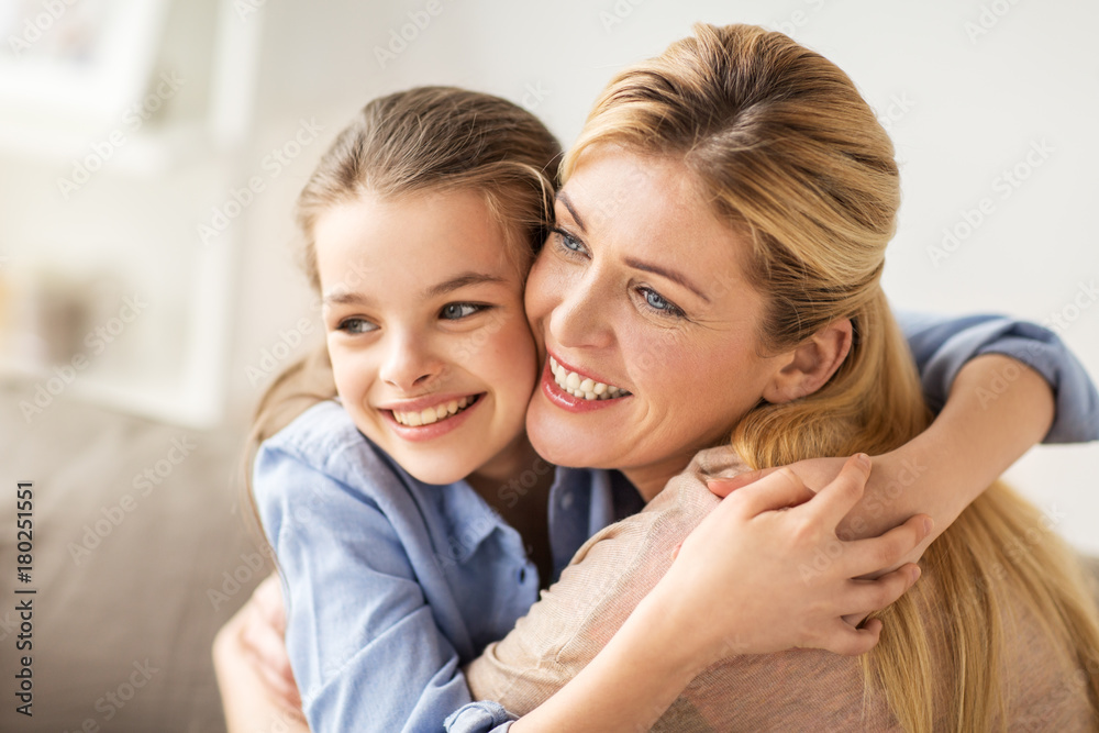 happy smiling family hugging on sofa at home