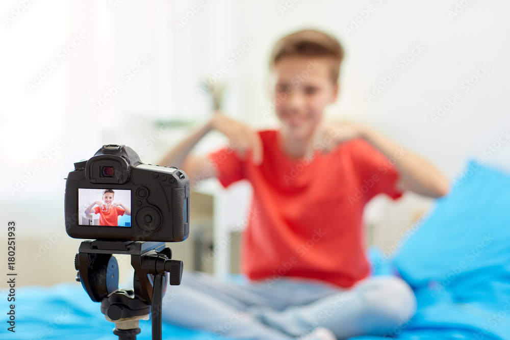 camera recording video of blogger boy at home