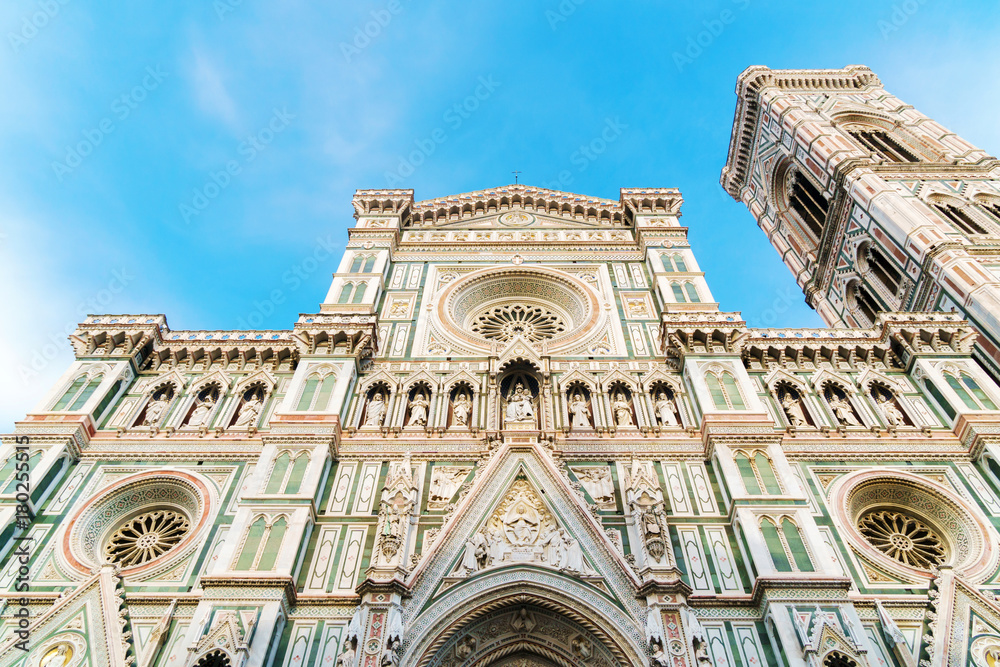 Santa Maria Del Fiore cathedral in Florence, Italy. Facade view and bright sky above.