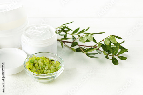 Spa concept with salt, mint, lotion, towel on white background