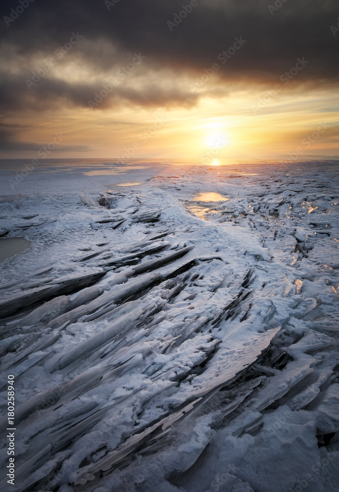 Winter landscape with frozen lake and sunset sky. Winter landscape with frozen lake and sunset sky.
