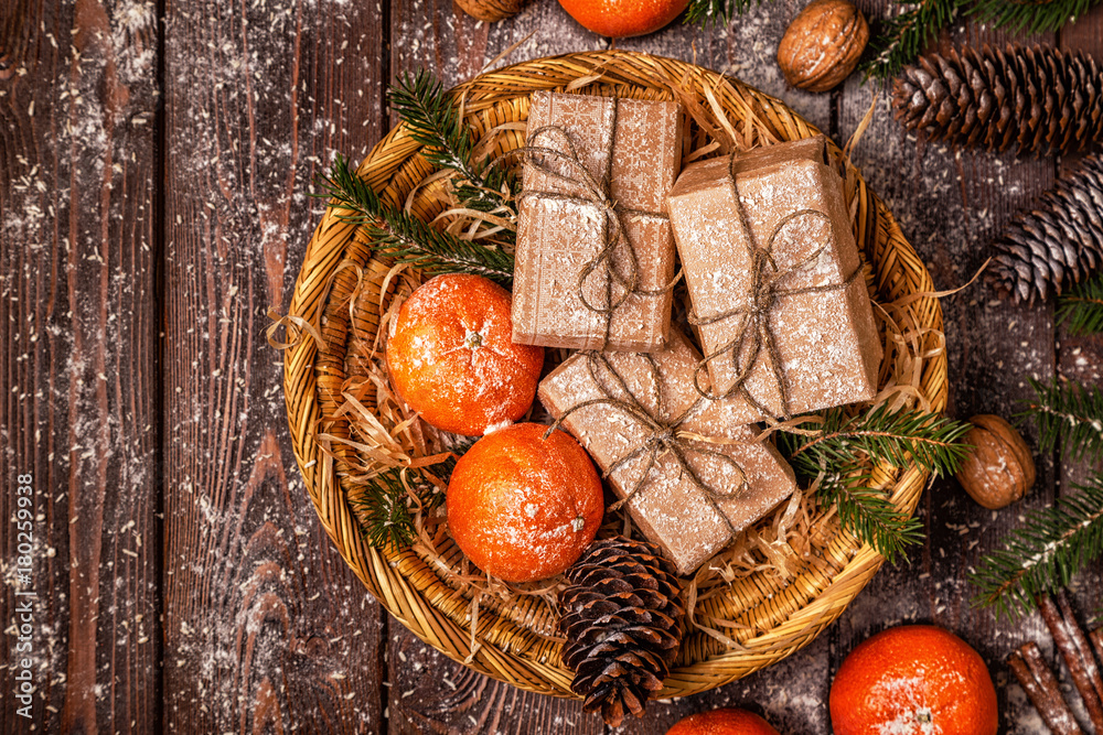 Christmas composition with tangerines, gift boxes, cones on a dark wooden background. Christmas composition with tangerines, gift boxes, cones on a dark wooden background.