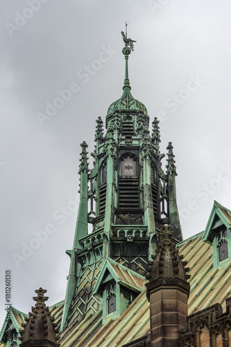 Photography Sydney, Australia - March 25, 2017: Closeup of historic green bronze decorated spire on top of Maclaurin Hall at University of Sydney under heavy sky