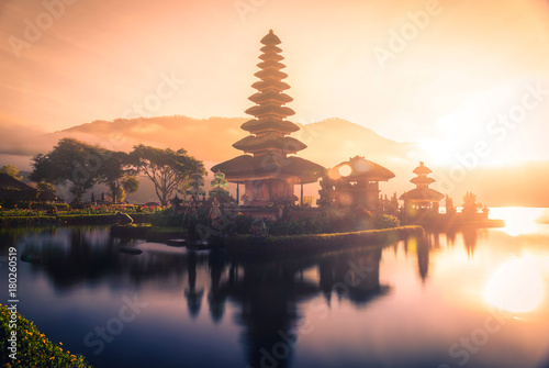 Pura Ulun Danu Bratan  Hindu temple on Bratan lake landscape with lens flare at sunrise in Bali  Indonesia.