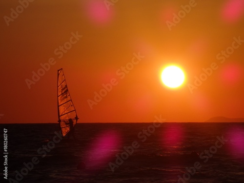 Sailing at sunset orange sky