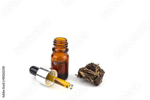 Medicinal cannabis with extract oil in a bottle isolated on white background