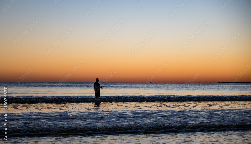 single fisherman in the surf at Fort Myers Beach