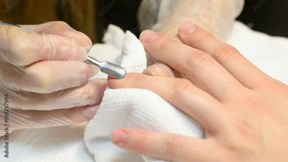 manicurist removing cuticle from the nail manicurist removing cuticle from the nail
