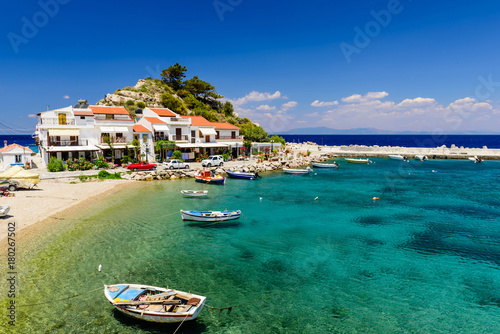 The picturesque village of Kokkari with traditional houses and fishing boats. Kokkari village is a popular tourist place on the island of Samos. photo