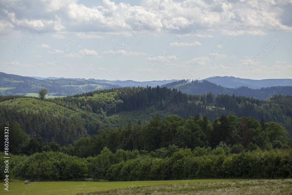 Beautiful Czech summer landscape on hills with forest