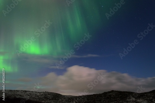 Night over the hills clouds and Aurora.