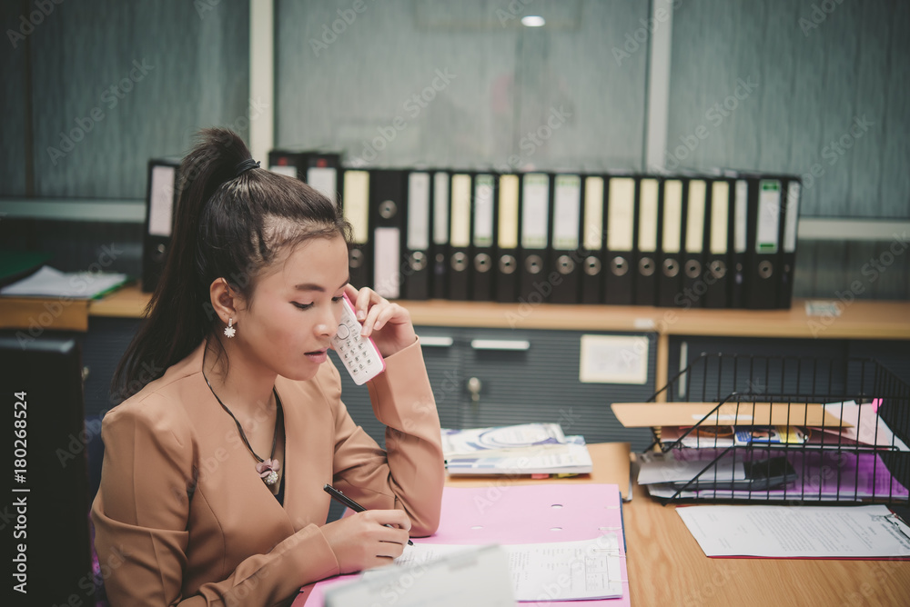 Thai business woman talk telephone with customers,Asian clerk in working day