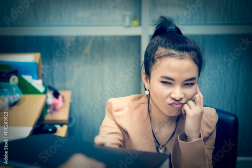 Asian stress business woman in the office recieve hard work from boss she use hand touch head