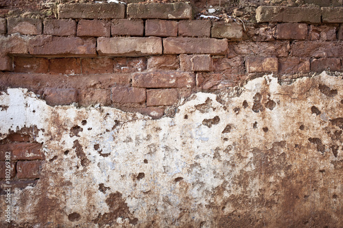 Old red damaged brick wall texture background